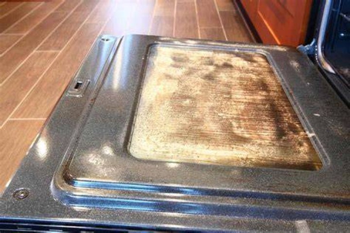 How do I get brown stains off my glass oven door?